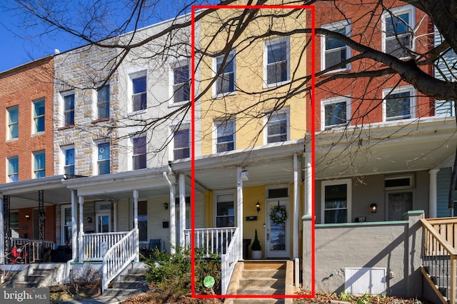 townhome / multi-family property featuring covered porch