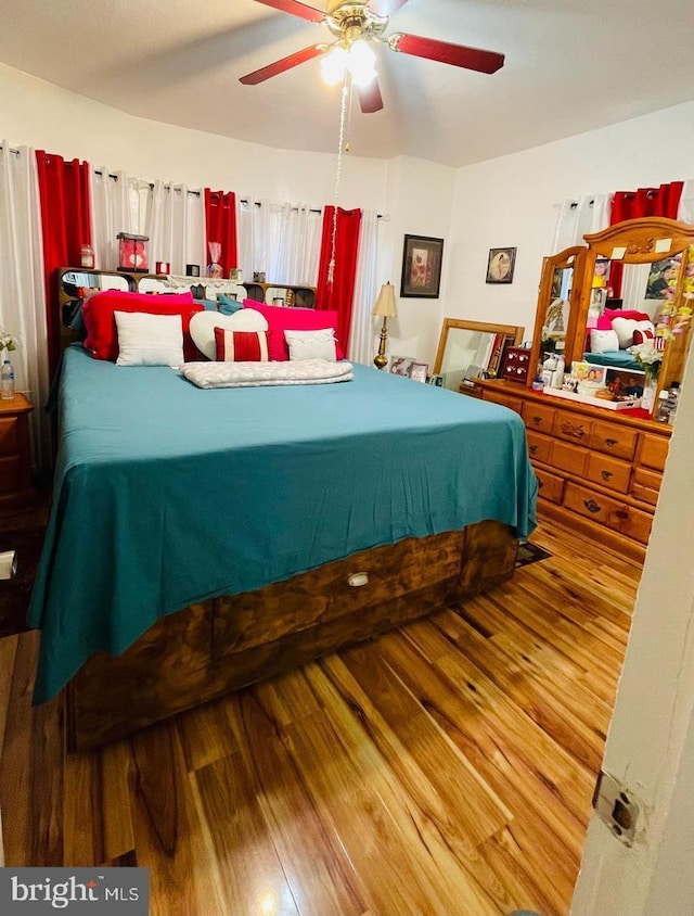 bedroom with hardwood / wood-style flooring and ceiling fan