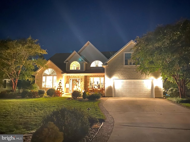 view of front of home featuring a garage and a lawn