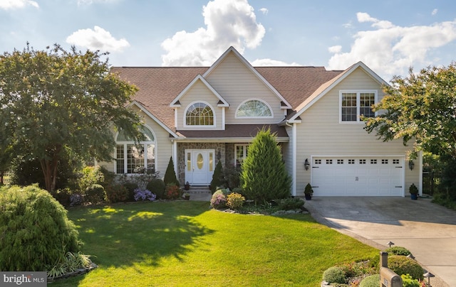 view of front of property featuring a garage and a front yard