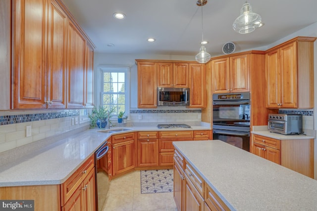 kitchen featuring light tile patterned flooring, appliances with stainless steel finishes, pendant lighting, tasteful backsplash, and sink