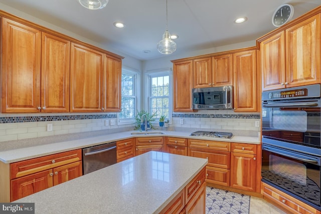 kitchen featuring appliances with stainless steel finishes, decorative light fixtures, tasteful backsplash, sink, and light tile patterned floors