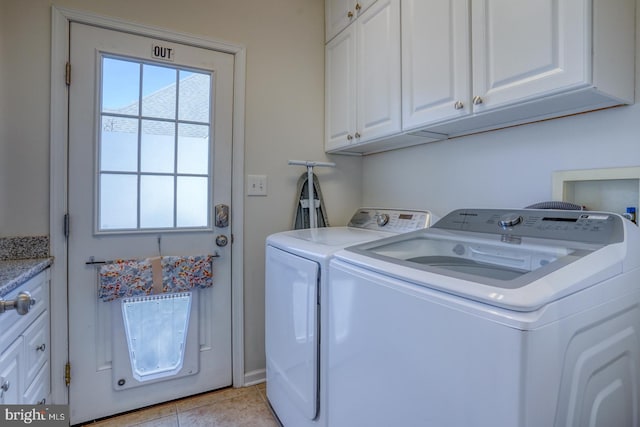 washroom featuring cabinets, light tile patterned floors, and independent washer and dryer