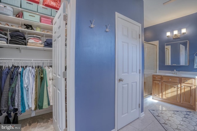 bathroom with vanity, tile patterned floors, and walk in shower