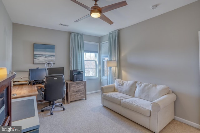 carpeted home office with ceiling fan