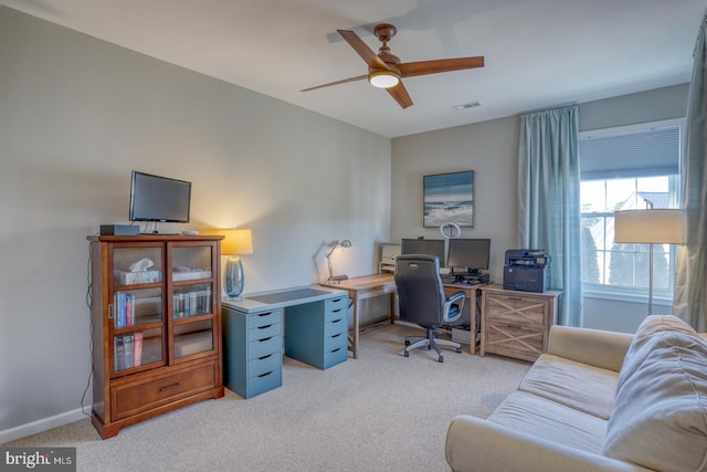 carpeted home office with ceiling fan