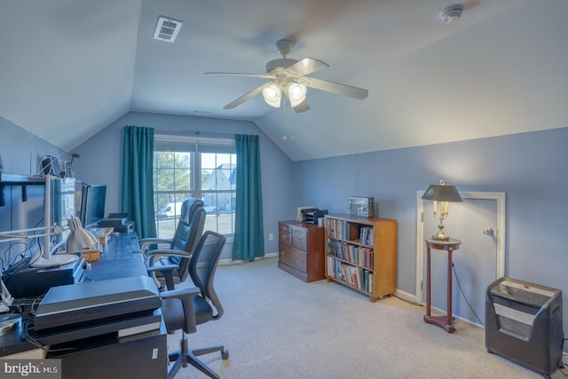 home office with lofted ceiling, ceiling fan, and carpet