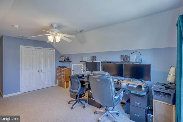 home office featuring ceiling fan, vaulted ceiling, and light carpet