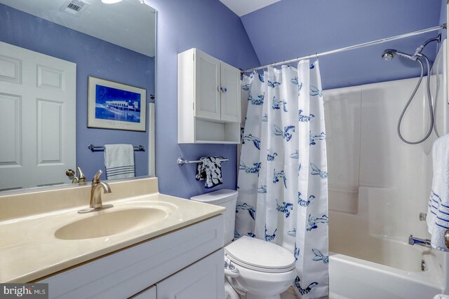 full bathroom with vanity, shower / bathtub combination with curtain, and toilet