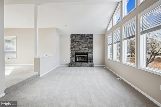 unfurnished living room with light colored carpet, a fireplace, and high vaulted ceiling