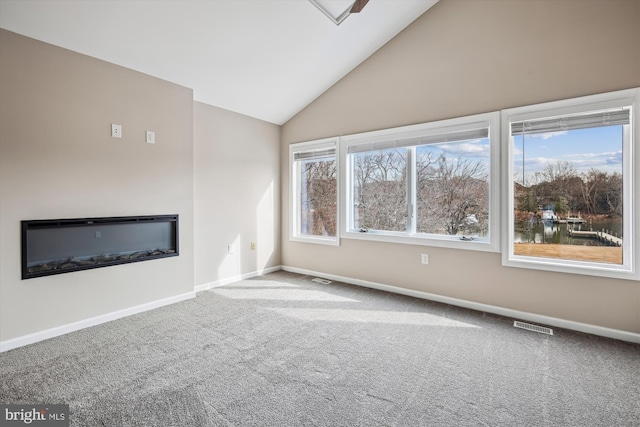 unfurnished living room featuring lofted ceiling, carpet flooring, and a water view