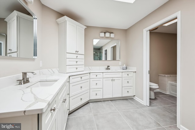 bathroom featuring tile patterned floors, toilet, and vanity