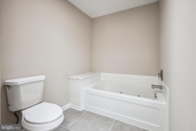 bathroom featuring tile patterned flooring, a tub, and toilet