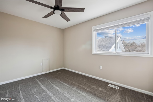 unfurnished room with ceiling fan and dark colored carpet