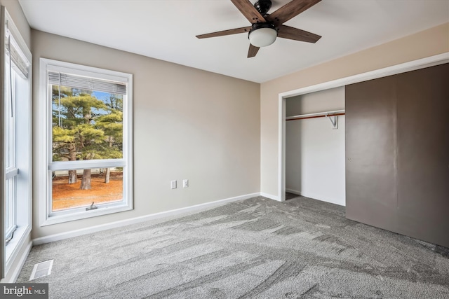 unfurnished bedroom with a closet, ceiling fan, and carpet flooring