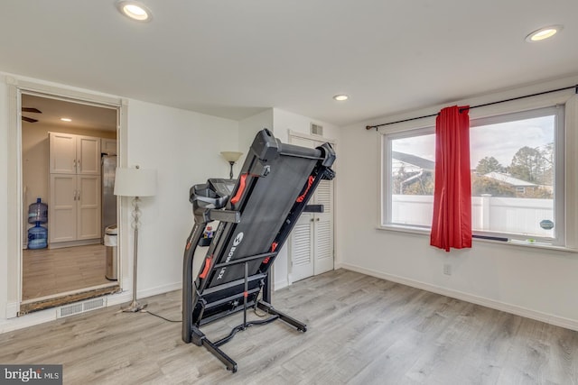 exercise room featuring light wood-type flooring