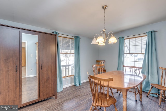 dining room featuring a notable chandelier and dark hardwood / wood-style flooring