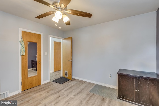 empty room featuring ceiling fan and light wood-type flooring