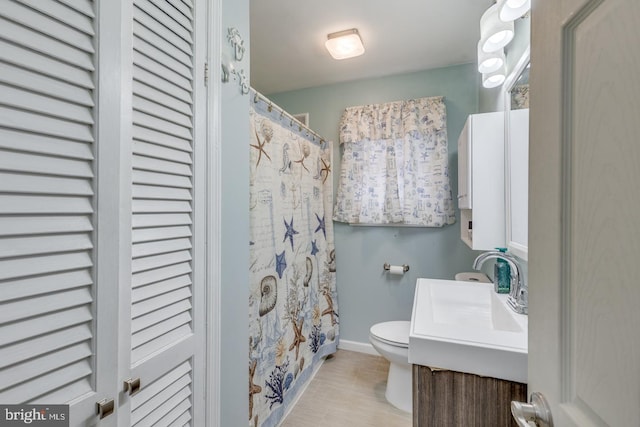 bathroom featuring vanity, toilet, and walk in shower