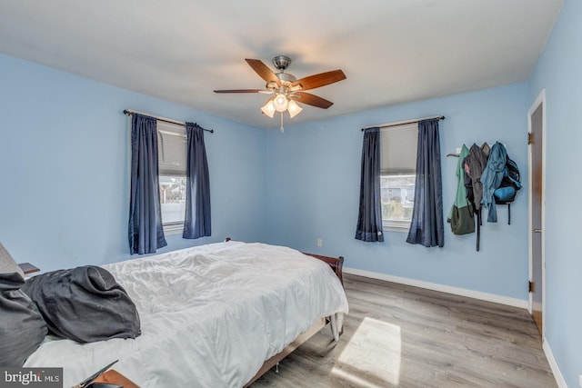 bedroom with ceiling fan and light wood-type flooring