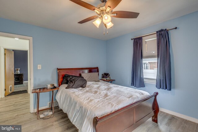 bedroom with ceiling fan and light hardwood / wood-style floors