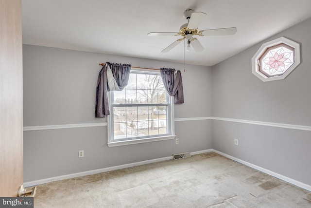 carpeted spare room with ceiling fan