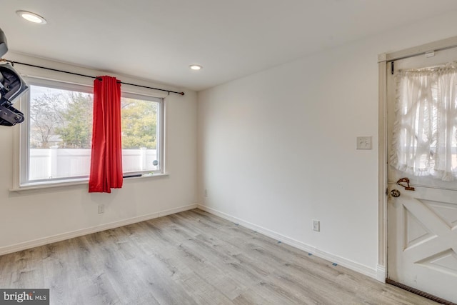 empty room with light hardwood / wood-style floors