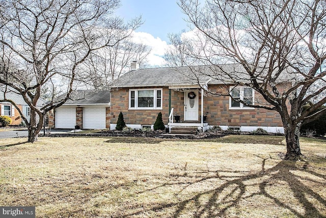 view of front of home featuring a garage and a front lawn