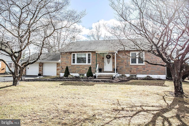 view of front of property featuring a garage and a front lawn