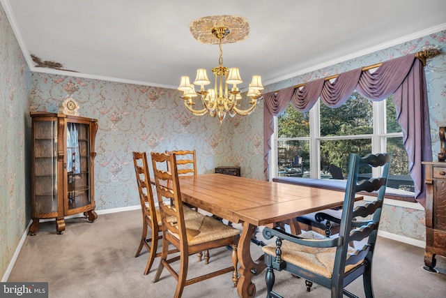 dining room featuring ornamental molding, a chandelier, and carpet flooring