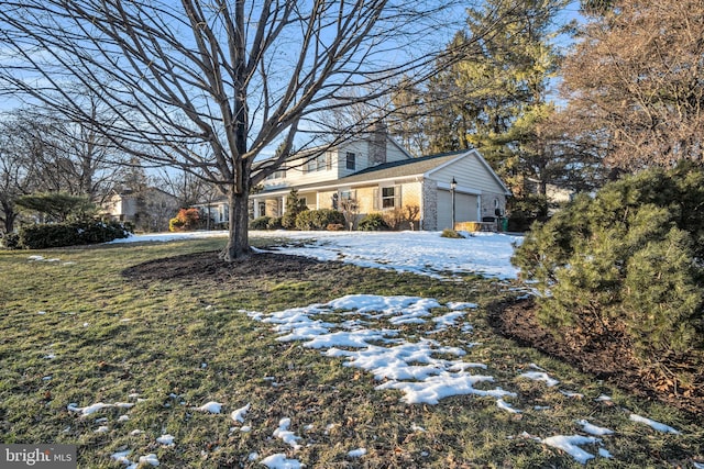 yard covered in snow with a garage