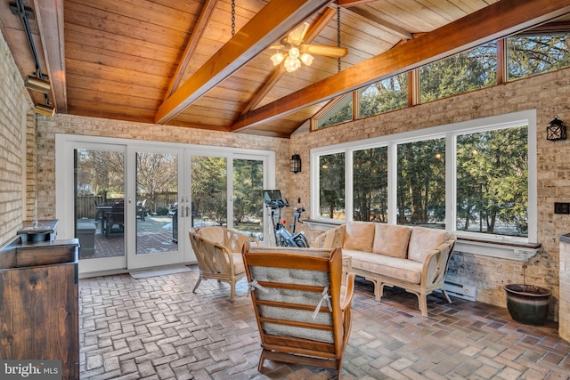 sunroom / solarium featuring vaulted ceiling with beams, a wealth of natural light, wooden ceiling, and ceiling fan