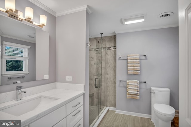 bathroom with toilet, crown molding, vanity, a shower with door, and hardwood / wood-style floors