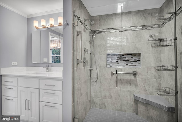 bathroom featuring crown molding, tiled shower, and vanity