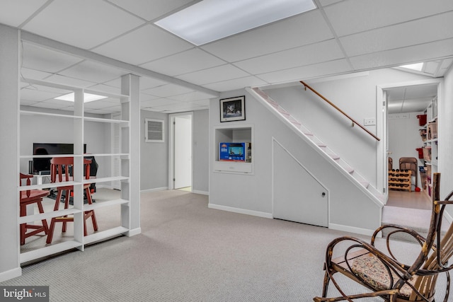 sitting room featuring light carpet and a drop ceiling