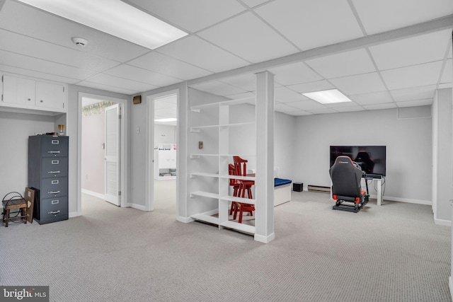 workout area with light carpet, a baseboard radiator, and a paneled ceiling