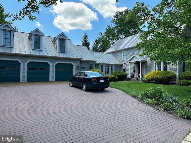 view of front of house with a garage and a front yard