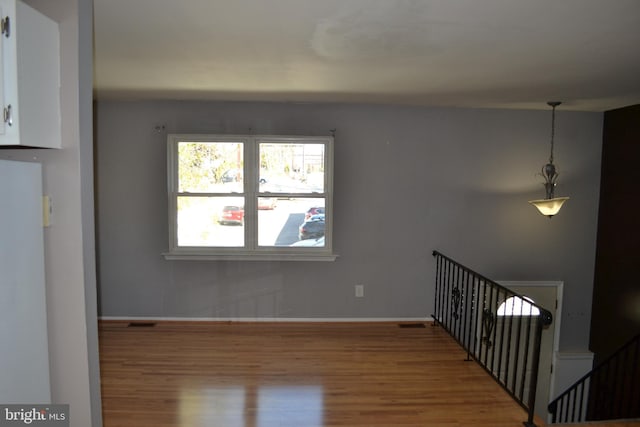 unfurnished room with hardwood / wood-style floors