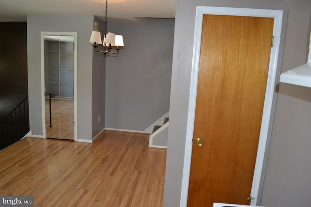 interior space featuring a chandelier and light hardwood / wood-style floors