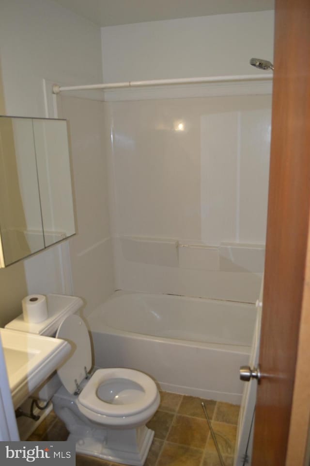 bathroom featuring tile patterned flooring, shower / bathtub combination, and toilet