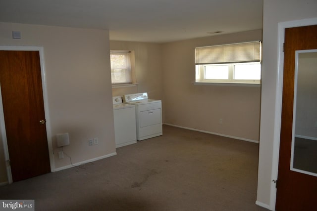 laundry area with a healthy amount of sunlight, light colored carpet, and washing machine and clothes dryer