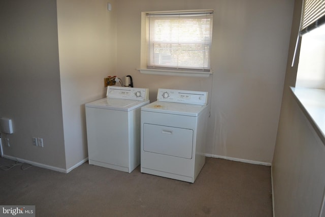 laundry area featuring washer and clothes dryer and light colored carpet