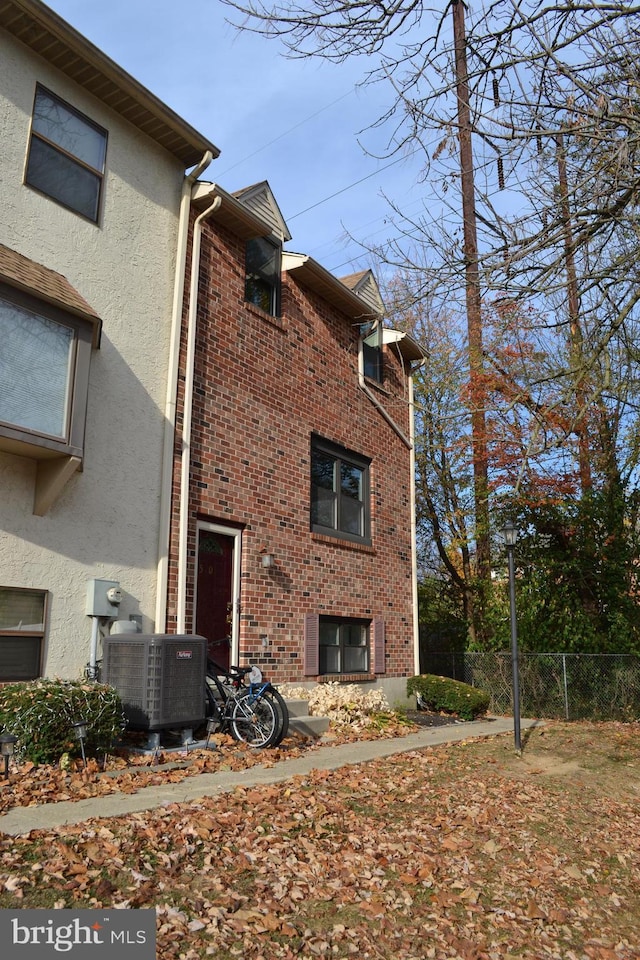 view of side of property featuring central air condition unit