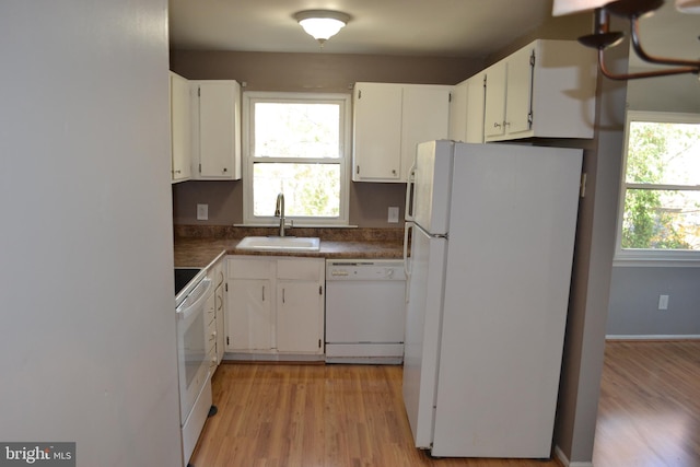 kitchen featuring light wood-type flooring, white appliances, sink, and white cabinets