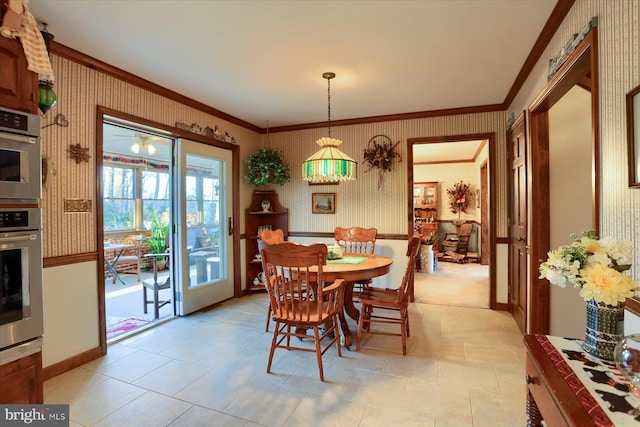 dining space featuring crown molding