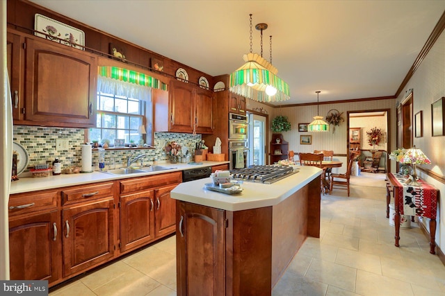 kitchen with decorative light fixtures, sink, a center island, stainless steel appliances, and crown molding