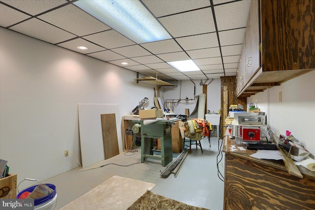 basement featuring sink and a paneled ceiling