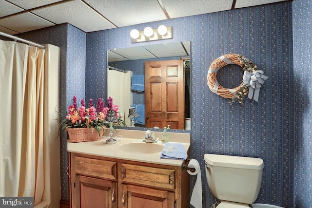 bathroom with vanity, a paneled ceiling, toilet, and a shower with shower curtain