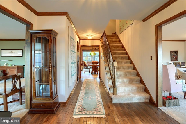 corridor featuring hardwood / wood-style flooring and ornamental molding