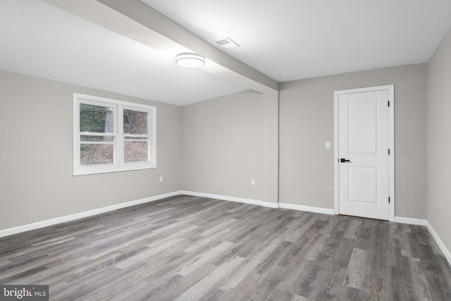 empty room with hardwood / wood-style flooring